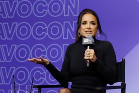 Kyle Richards in a black sweater holding her hand out and talking into a microphone at BravoCon 2025