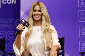 Kim Zolciak on stage at BravoCon 2025 holding a microphone